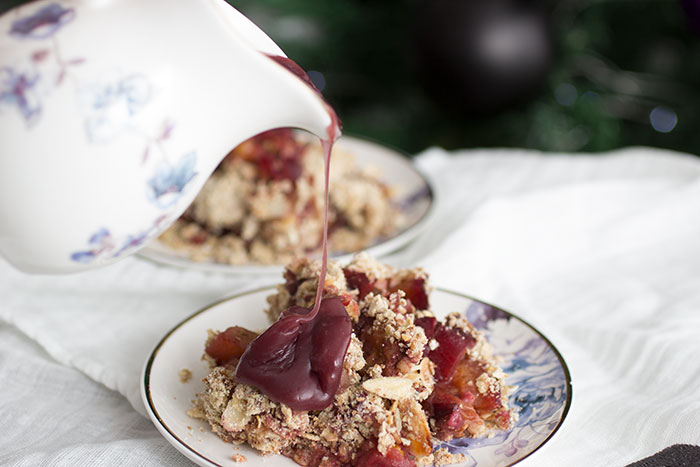 Plum Crumble with Mulled Wine Custard. Custard is poured over the crumble