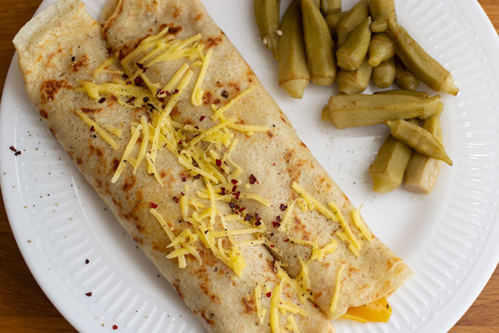 Onion and pepper crepes. Plated with pickled okra